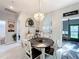 Cozy dining room features white wood flooring and a stylish chandelier at 13421 Via Roma Cir, Clermont, FL 34711