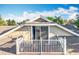 View of a roof-top balcony with white railings attached to a home with light beige siding and a sliding glass door at 13421 Via Roma Cir, Clermont, FL 34711