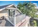 A unique roof-top balcony with white railings is attached to a home with light beige siding in this exterior view at 13421 Via Roma Cir, Clermont, FL 34711