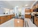 Kitchen island with sink, stainless steel appliances, and adjacent breakfast bar seating at 13421 Via Roma Cir, Clermont, FL 34711