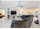 Spacious living room features a modern ceiling fan, built-in shelving, and neutral decor at 13421 Via Roma Cir, Clermont, FL 34711