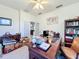 Office space featuring a large wooden desk, bookshelf, and a comfortable leather chair, great for a home office at 13421 Via Roma Cir, Clermont, FL 34711