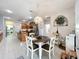 Bright open floorplan kitchen and dining area, featuring modern appliances and elegant chandelier at 13421 Via Roma Cir, Clermont, FL 34711