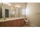 Bathroom with dual sink vanity, a large mirror, and a separate shower stall at 1419 Segovia Pl, The Villages, FL 32162