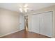 Bright bedroom featuring hardwood floors, neutral walls, ceiling fan, and closet at 1419 Segovia Pl, The Villages, FL 32162