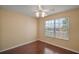 Cozy bedroom featuring hardwood floors, neutral walls, and a sunny window at 1419 Segovia Pl, The Villages, FL 32162