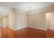 Dining area featuring hardwood floors, neutral walls, and an elegant chandelier at 1419 Segovia Pl, The Villages, FL 32162