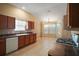 Bright kitchen features wood cabinets, tile floor, and an adjacent breakfast nook with bay windows at 1419 Segovia Pl, The Villages, FL 32162