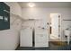 A practical laundry room with washer, dryer, storage, and utility sink at 1419 Segovia Pl, The Villages, FL 32162