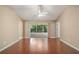 Inviting living room featuring hardwood floors, neutral walls, and sliding glass doors to a screened in lanai at 1419 Segovia Pl, The Villages, FL 32162