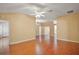 Open-concept living room featuring hardwood floors, a vaulted ceiling, and neutral paint at 1419 Segovia Pl, The Villages, FL 32162