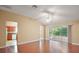 Bright living room boasting hardwood floors, a ceiling fan, and sliding door access to the lanai at 1419 Segovia Pl, The Villages, FL 32162