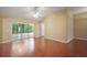 Spacious living room showcasing hardwood floors, a ceiling fan, and sliding doors to an outdoor lanai at 1419 Segovia Pl, The Villages, FL 32162