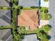 Aerial view of the home showcasing a barrel tile roof, mature landscaping, and manicured lawn at 1430 Hillstream St, The Villages, FL 32163