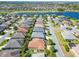 Community aerial view of homes featuring mature landscaping, community ponds, and golf course at 1430 Hillstream St, The Villages, FL 32163