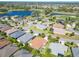 Aerial view of homes with mature landscaping, community ponds, and golf course at 1430 Hillstream St, The Villages, FL 32163