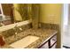 Close-up of a bathroom vanity with granite countertop, modern faucet, and decorative accents at 1430 Hillstream St, The Villages, FL 32163