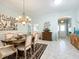 Well-lit dining room featuring elegant furnishings, a chandelier, and an open view to adjacent rooms at 1430 Hillstream St, The Villages, FL 32163