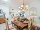 Elegant dining room featuring a chandelier, classic furniture, and seamless access to other living spaces at 1430 Hillstream St, The Villages, FL 32163