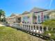 Inviting exterior showcasing the home's manicured lawn, stately columns, and charming front porch at 1430 Hillstream St, The Villages, FL 32163