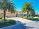 Charming home with lush landscaping, mature palms, and a large driveway at 1430 Hillstream St, The Villages, FL 32163