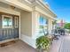 Charming front porch with ample seating, stylish decor, and a welcoming entrance to the home at 1430 Hillstream St, The Villages, FL 32163