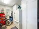 Garage with storage, white refrigerator, bicycle, tool chest, and utility closet at 1430 Hillstream St, The Villages, FL 32163