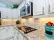 Close-up of a kitchen featuring granite countertops and modern appliances at 1430 Hillstream St, The Villages, FL 32163