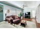 Bright living room featuring hardwood floors, a ceiling fan, and a comfortable brown leather sofa at 1430 Hillstream St, The Villages, FL 32163