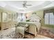 Tranquil bedroom featuring a tray ceiling, shutters, and a plush rug, creating a relaxing retreat at 1430 Hillstream St, The Villages, FL 32163