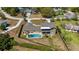 Beautiful aerial view of this home with a pool, fenced yard, lush landscaping, and outdoor living space at 16109 Hillside Cir, Montverde, FL 34756