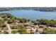 Stunning aerial view of a lakeside property with a pool and mature landscaping, perfect for luxurious living at 16109 Hillside Cir, Montverde, FL 34756