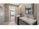 Modern bathroom with double vanities and a view into a bedroom at 16109 Hillside Cir, Montverde, FL 34756