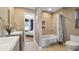 Contemporary bathroom featuring a tiled shower-tub combination and a view into an adjacent bedroom at 16109 Hillside Cir, Montverde, FL 34756