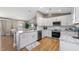 Open concept kitchen with white cabinets, stainless steel appliances, granite countertops and adjacent dining space at 16109 Hillside Cir, Montverde, FL 34756