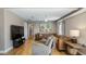 Well-lit living room with neutral tones, comfortable seating, and wood floors at 16109 Hillside Cir, Montverde, FL 34756