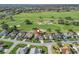 Expansive aerial view highlights a home set in a golf course community with lakes and ponds in the distance at 1726 Augustine Dr, The Villages, FL 32159