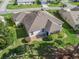 Aerial view showcasing the rear exterior of a well maintained home and backyard with mature landscaping at 1726 Augustine Dr, The Villages, FL 32159