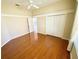 Spacious bedroom with hardwood floors, crown molding, and a walk-in closet at 1726 Augustine Dr, Lady Lake, FL 32159