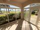 This Florida room has ample sunlight, beautiful views of the golf course and landscaping at 1726 Augustine Dr, Lady Lake, FL 32159