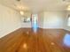 Bright living room with hardwood floors, chandelier, and view of the entryway at 1726 Augustine Dr, The Villages, FL 32159