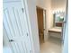 Bathroom vanity with large mirror and access to the toilet at 1726 Augustine Dr, The Villages, FL 32159