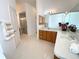 Bathroom featuring double vanity, bathtub, and a walk-in shower at 1726 Augustine Dr, The Villages, FL 32159