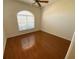 Bedroom with hardwood flooring and a large window at 1726 Augustine Dr, The Villages, FL 32159