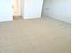 Neutral bedroom with a carpeted floor, showing access to the bathroom and a closet at 1726 Augustine Dr, The Villages, FL 32159