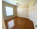 Bedroom with hardwood flooring, fan, and crown molding at 1726 Augustine Dr, The Villages, FL 32159
