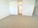 Bright bedroom with carpeted floor and doorways to the rest of the house at 1726 Augustine Dr, The Villages, FL 32159