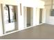 Spacious garage featuring multiple storage closets and utility access with epoxy flooring for easy maintenance at 1726 Augustine Dr, The Villages, FL 32159