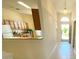 Entrance hallway leading to kitchen with view of wood cabinets and white appliances at 1726 Augustine Dr, The Villages, FL 32159