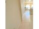 Hallway with neutral tile and view of arched window with natural light at 1726 Augustine Dr, The Villages, FL 32159